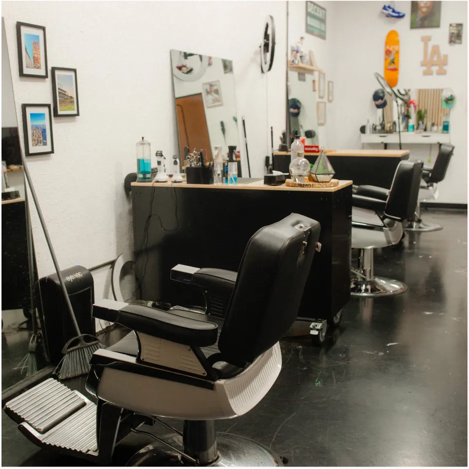 Multiple barber chairs and workstations inside a modern neighborhood barbershop studio in Lakeland, FL