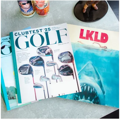 Magazines and local culture books on a coffee table inside a Lakeland, Florida barbershop studio