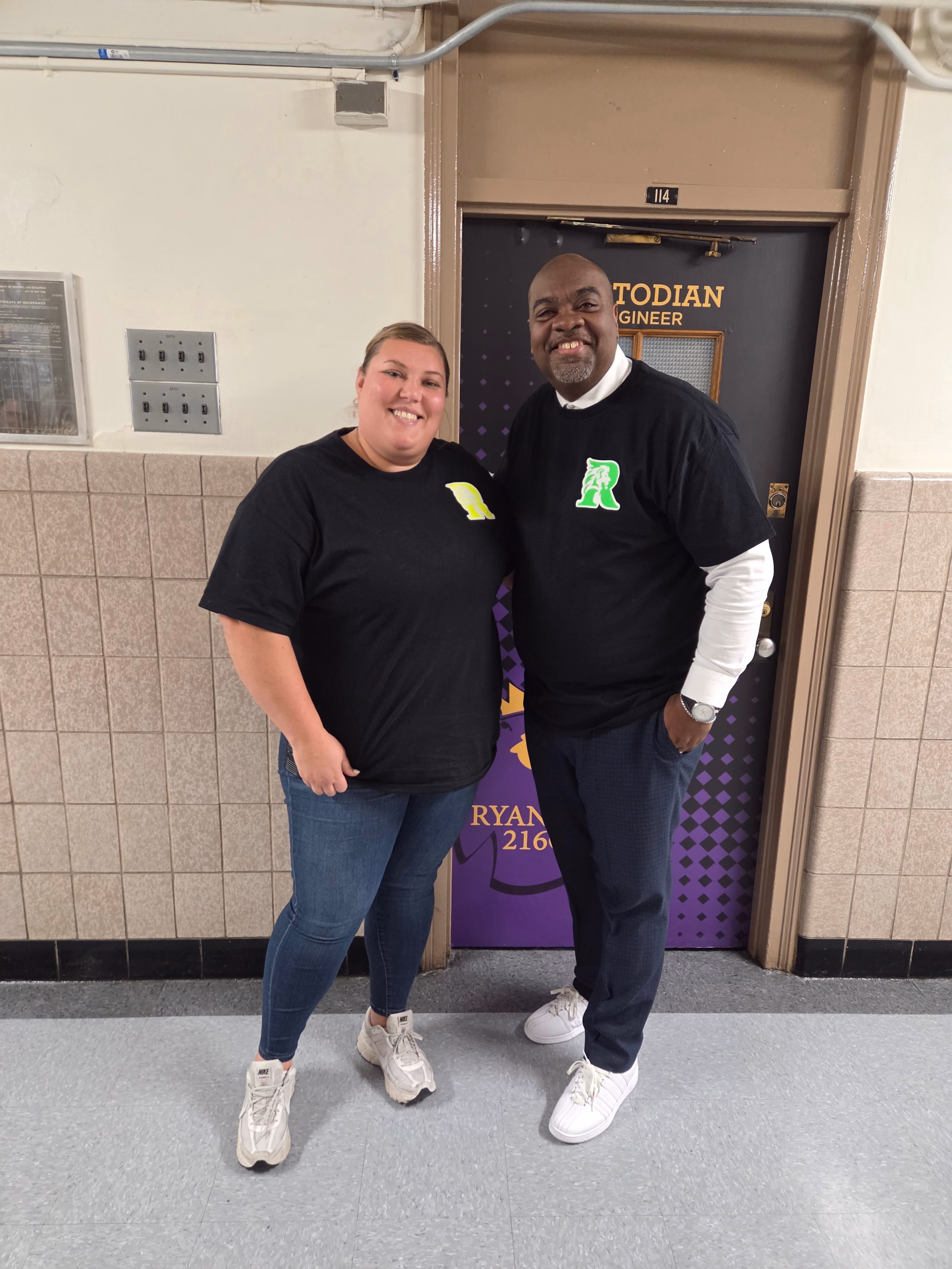 Two students posing in school hallway