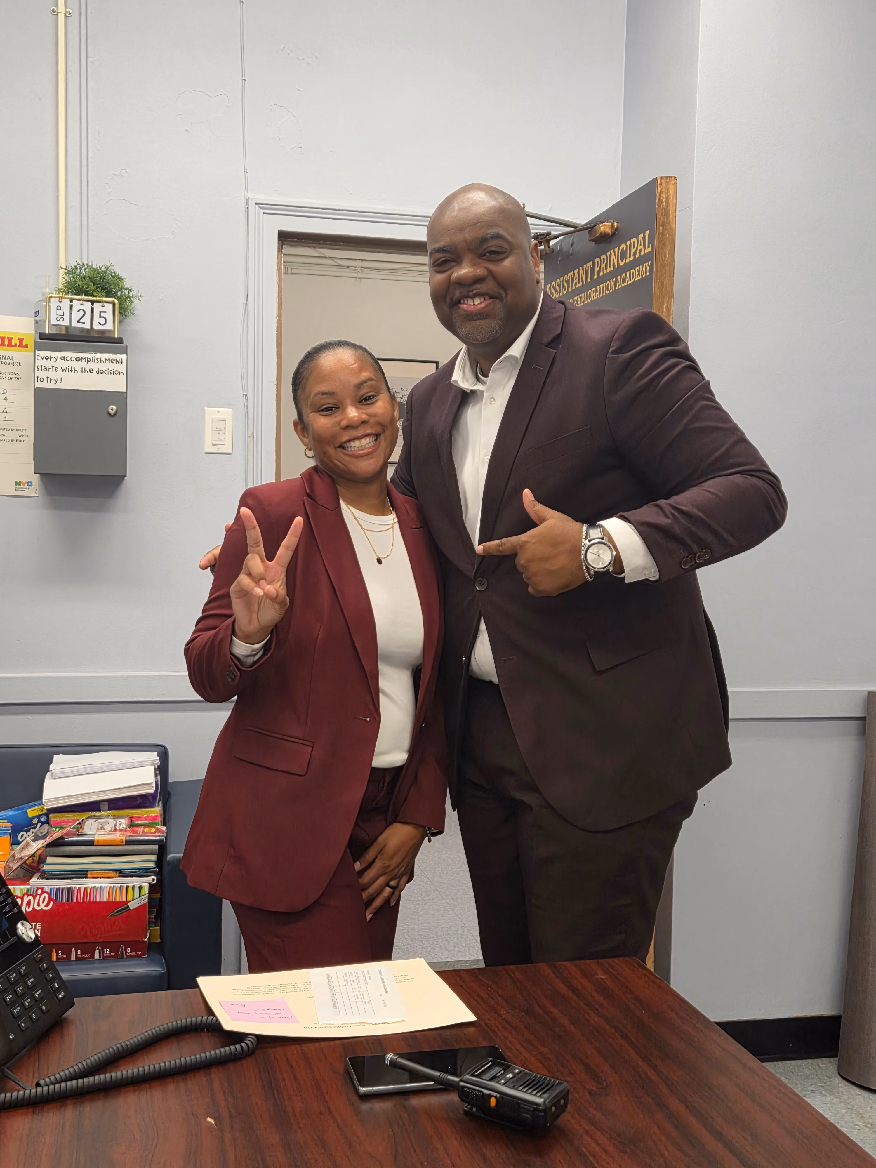 Two professionals posing together in an office