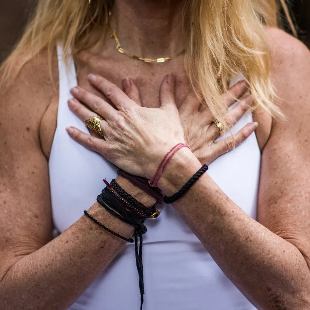 Closeup of Janet's hands in a heart mudra 
