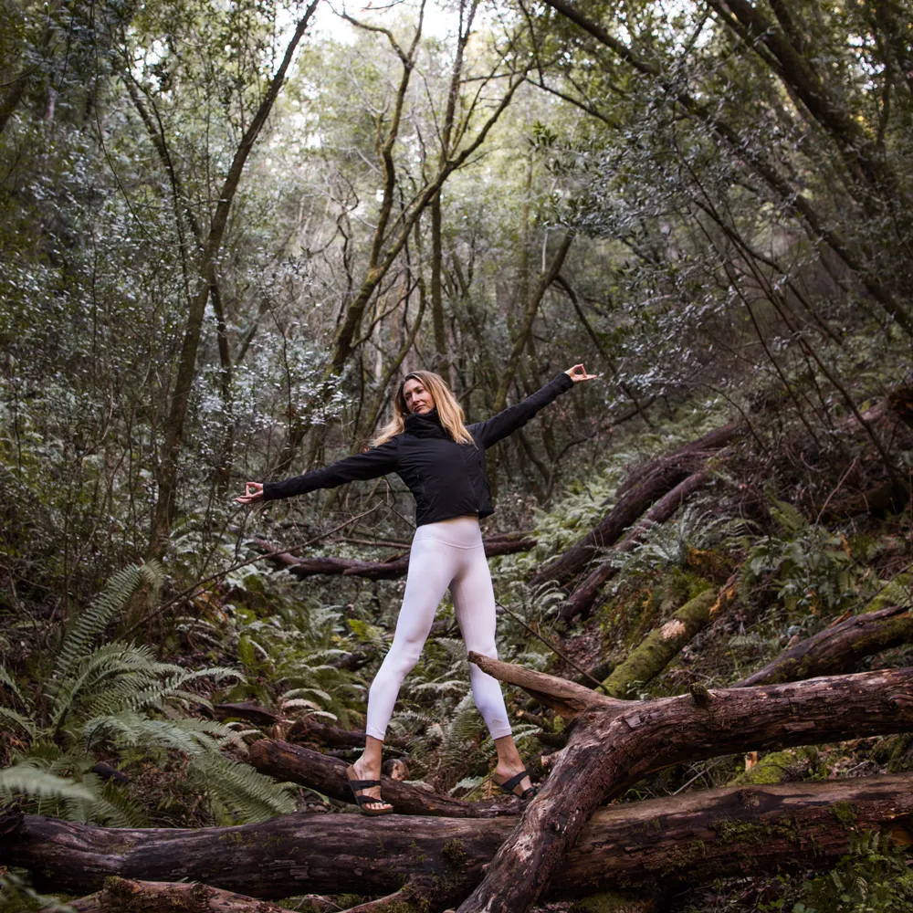 Janet in a heart opening pose in the forest