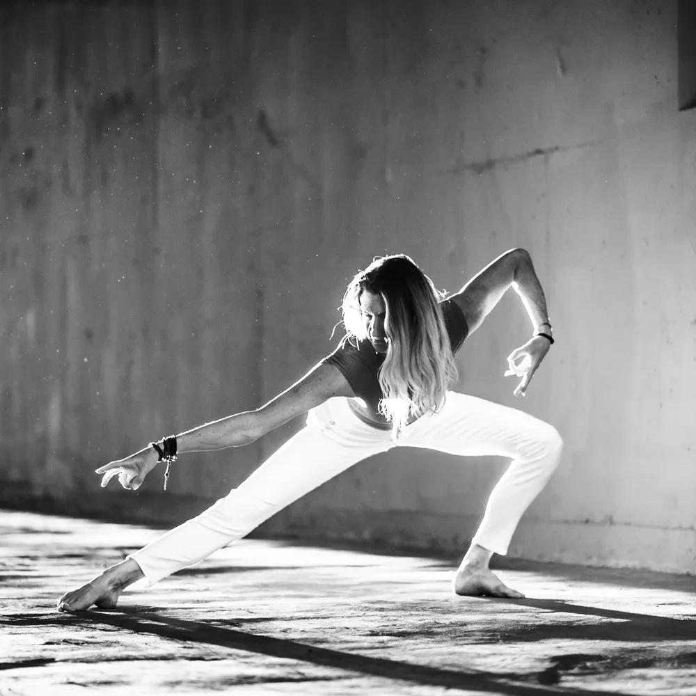 Janet in a crouching lunge with dramatic shadows