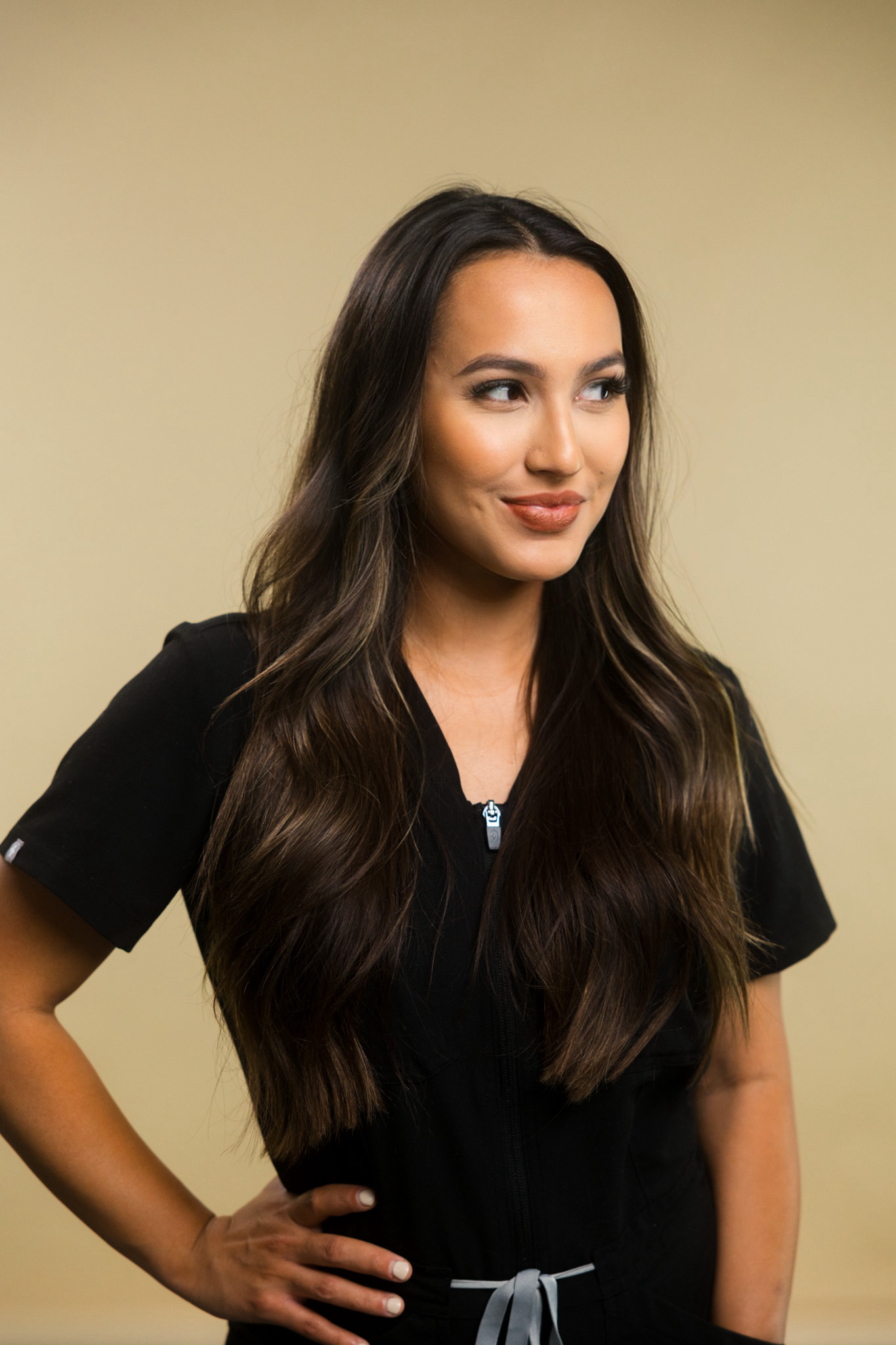A skincare professional consulting with a client about recurring acne treatment options in Queen Creek, Arizona while reviewing healthy skin care recommendations.