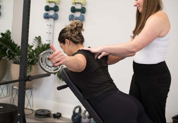 Patient working with a provider at a physical therapy clinic in Metairie, LA during a movement screen assessment