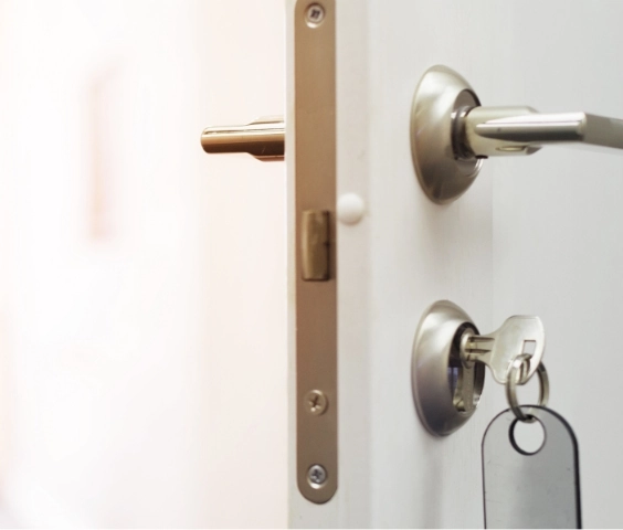 Secure key lock on alarmed door with delayed access in Flatrock care facility, enhancing safety provisions for residents.