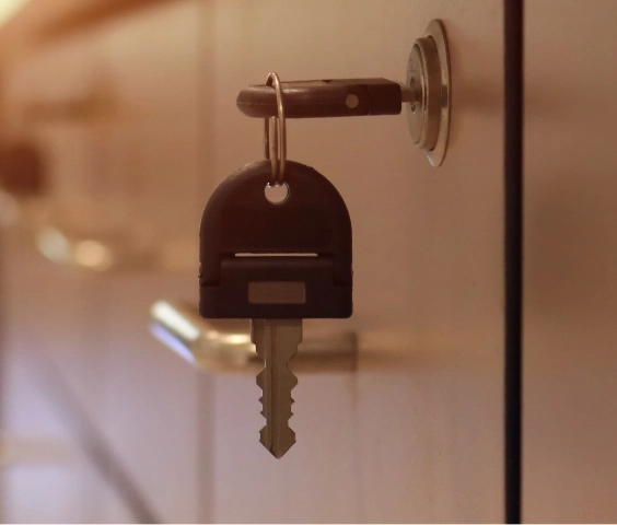 Close-up of key in locked medication room door at Flatrock, prioritizing resident security and peace of mind in daily living amenities.