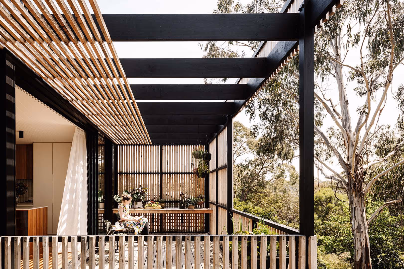 Lady reading on verandah