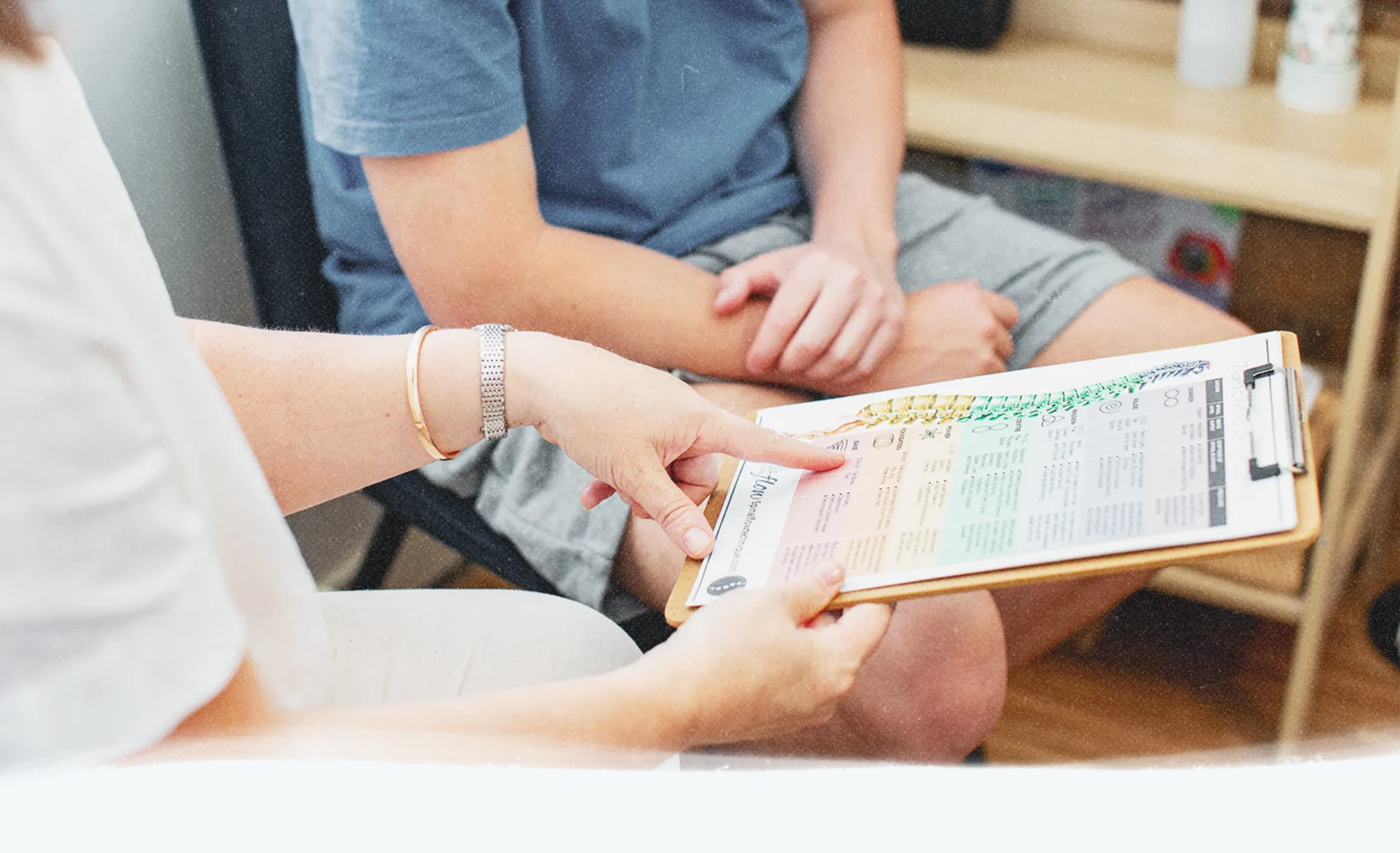 A practitioner pointing a part of spine
