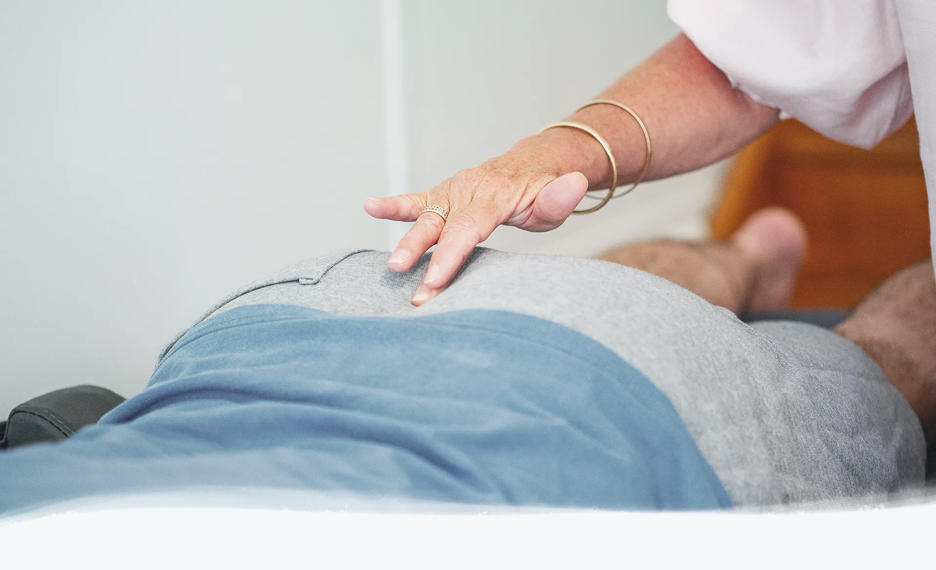 A practitioner that examines the back of patient