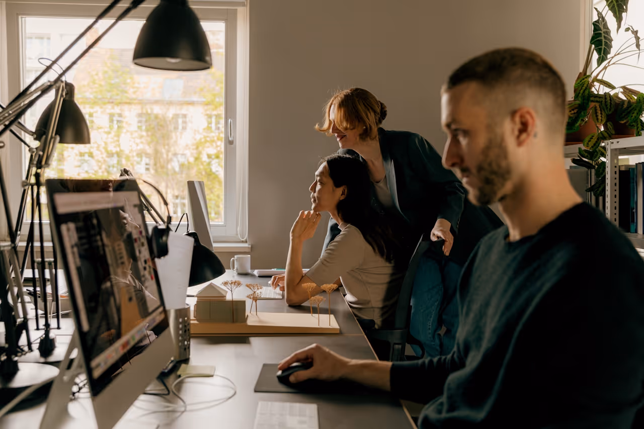 Team gathered around a workstation, illustrating data engineering and data collection.