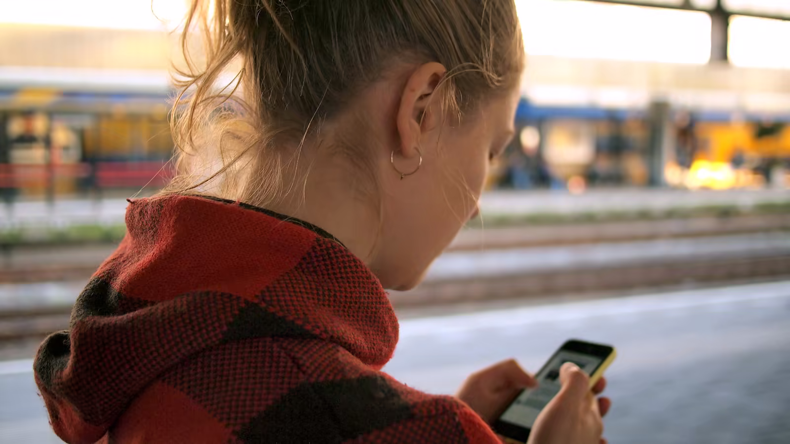A person on the move using a web service in a contemporary train station