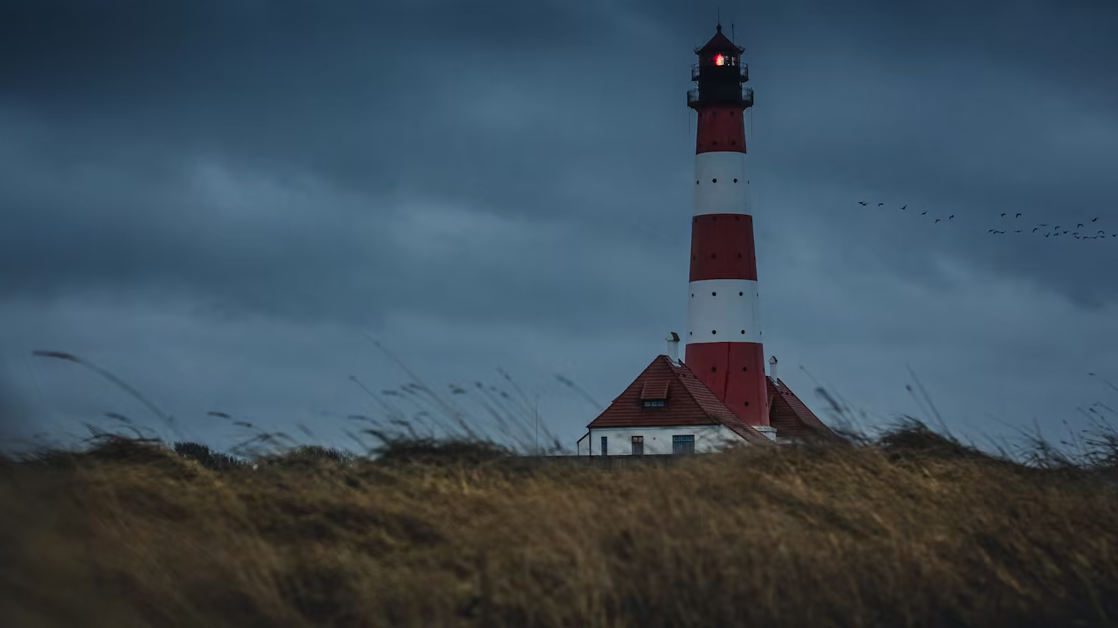A lighthouse and secondary marking maintaining navigation during a storm