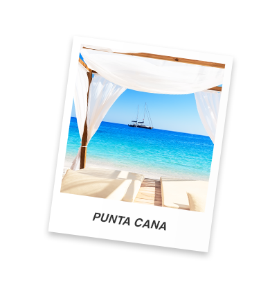 A polaroid of a beachfront view of the Caribbean with a sail boat on the horizon.