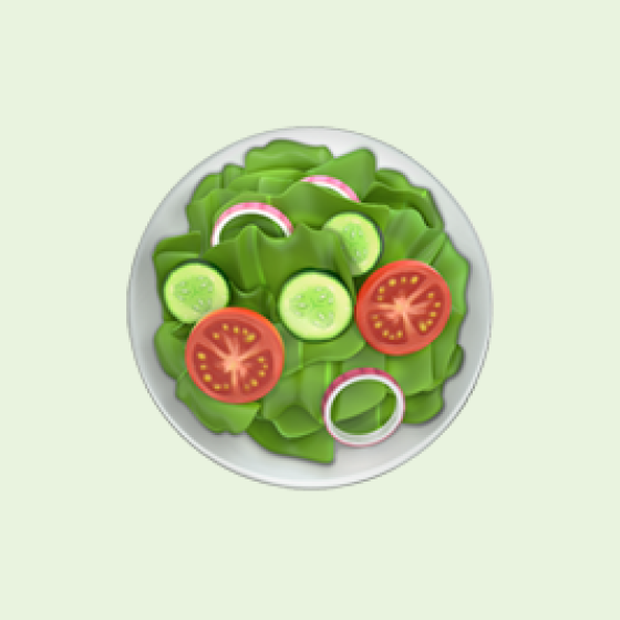 A white plate with green leafy salad, sliced cucumbers, tomato slices, and onion rings on a pale background