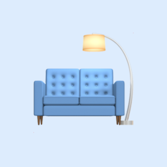 Blue tufted sofa with wooden legs and a curved floor lamp with cream shade beside it