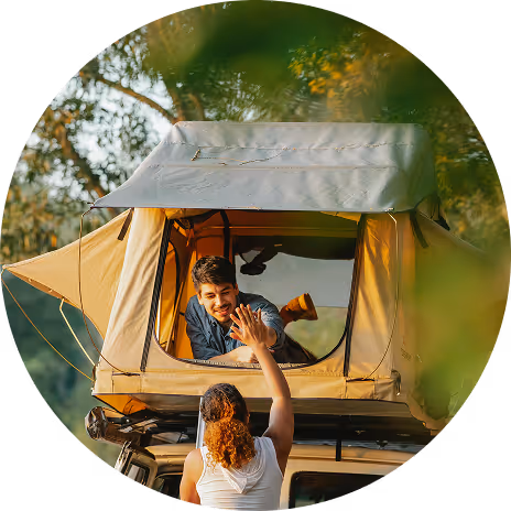 Two people communicating through a yellow tent window in a forest camping setting
