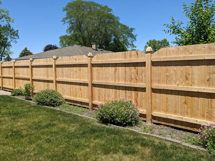 A tall cedar fence providing privacy and seclusion for a backyard.