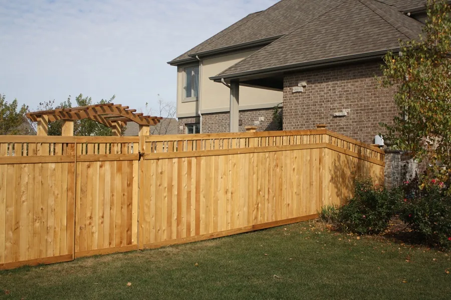 A cedar privacy fence with a decorative topper, adding a stylish touch.