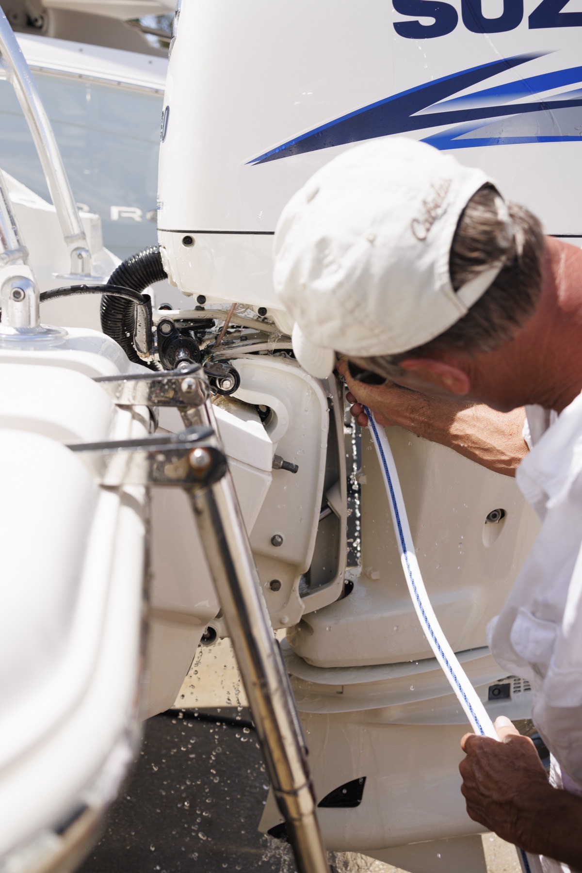 A PORT 32 technician flushing an outboard engine