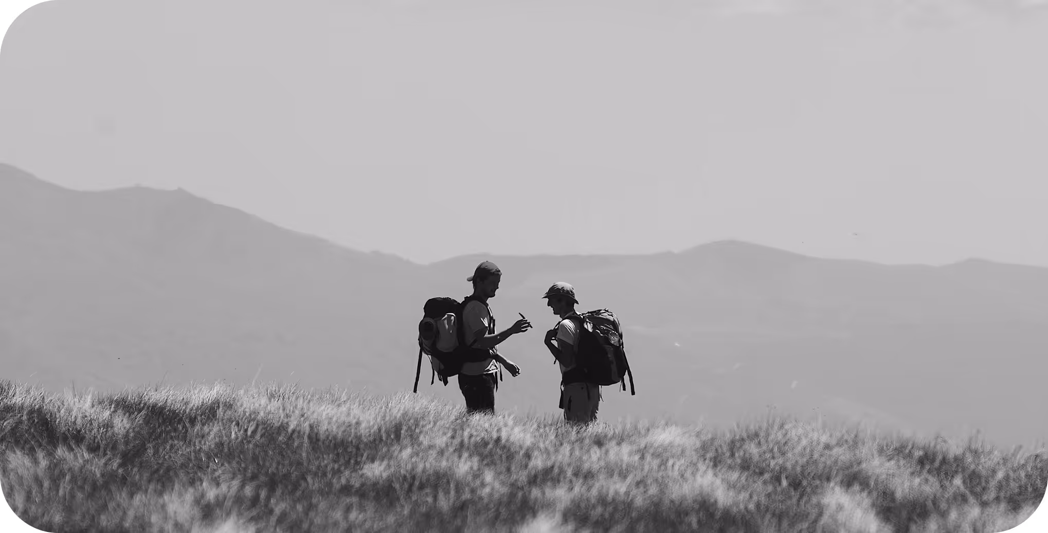 Two hikers discussing directions in nature – Journeyz customer journey mapping inspiration

