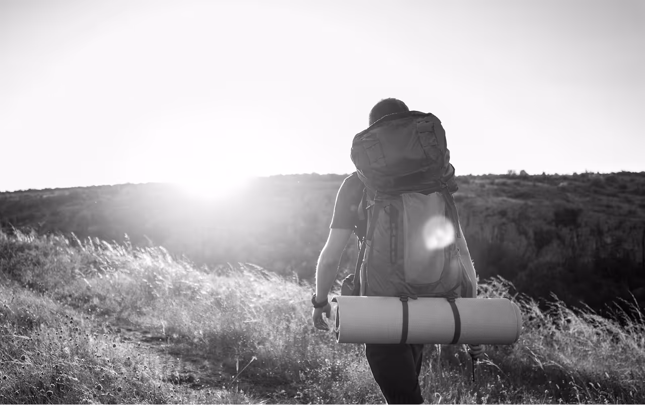 Journeyz platform depicted by a lone hiker walking toward sunrise, symbolizing starting a journey to transform customer retention and expansion strategies.