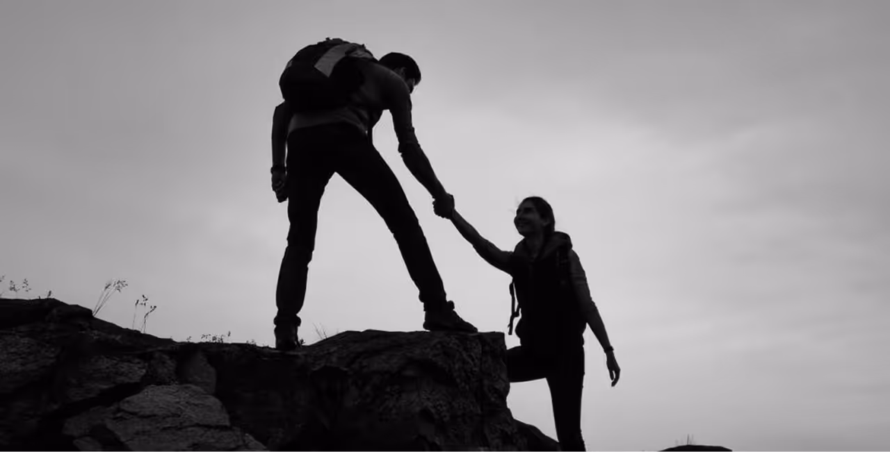 Journeyz partnership illustrated by two hikers helping each other on a cliff, symbolizing customer success teams collaborating to boost adoption, expand services, and drive new revenue.