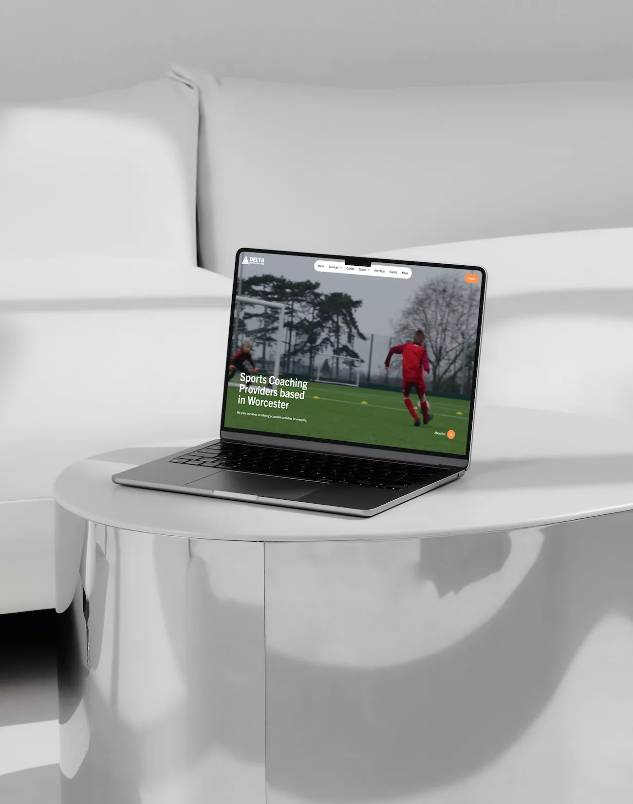 Delta Sports Coaching website homepage on a laptop, showing the sports coaching hero banner for their Worcester-based service