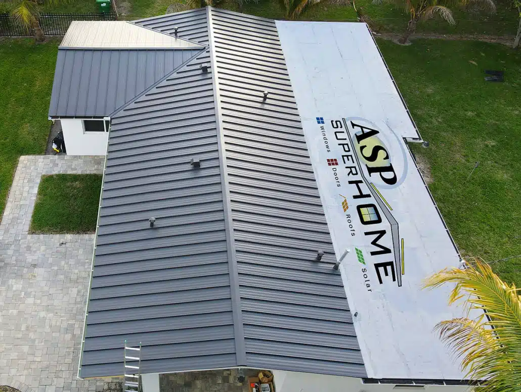 Aerial photo of gray standing seam metal roof. with the ASP SuperHome logo beside it.
