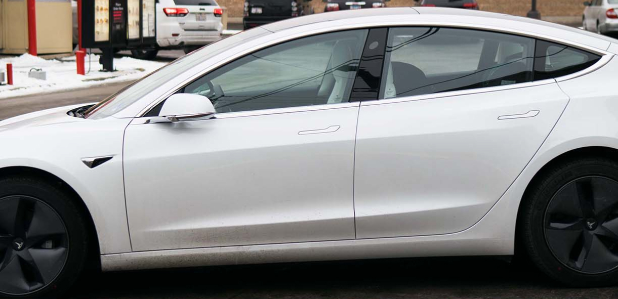 a white car parked on the side of the road