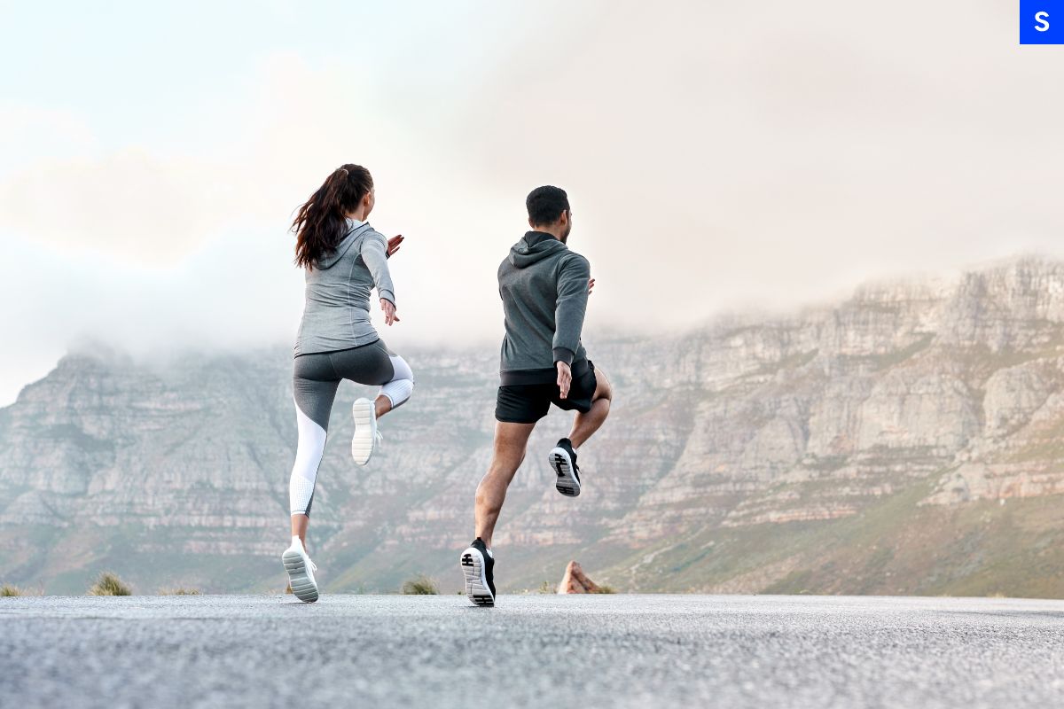 A man and a woman doing training together in the wilderness