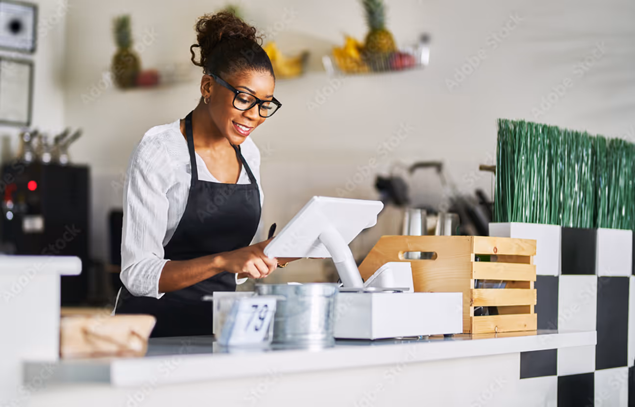 a woman looking towards laptop