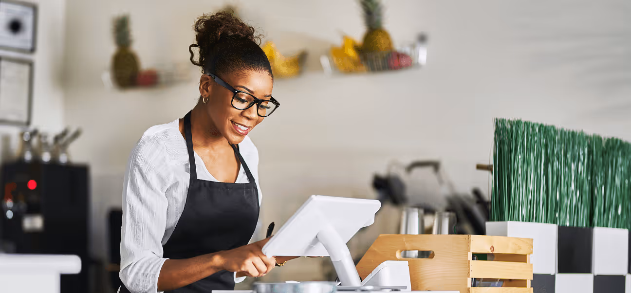 Retail staff using Kensium OrderPad tablet POS system for real-time inventory and checkout management.