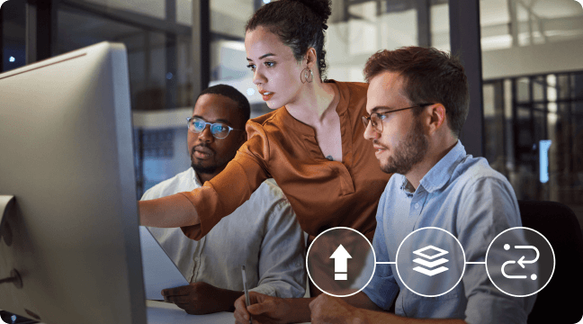 Smiling warehouse worker wearing an orange hard hat and holding a tablet, standing between shelves filled with boxes.