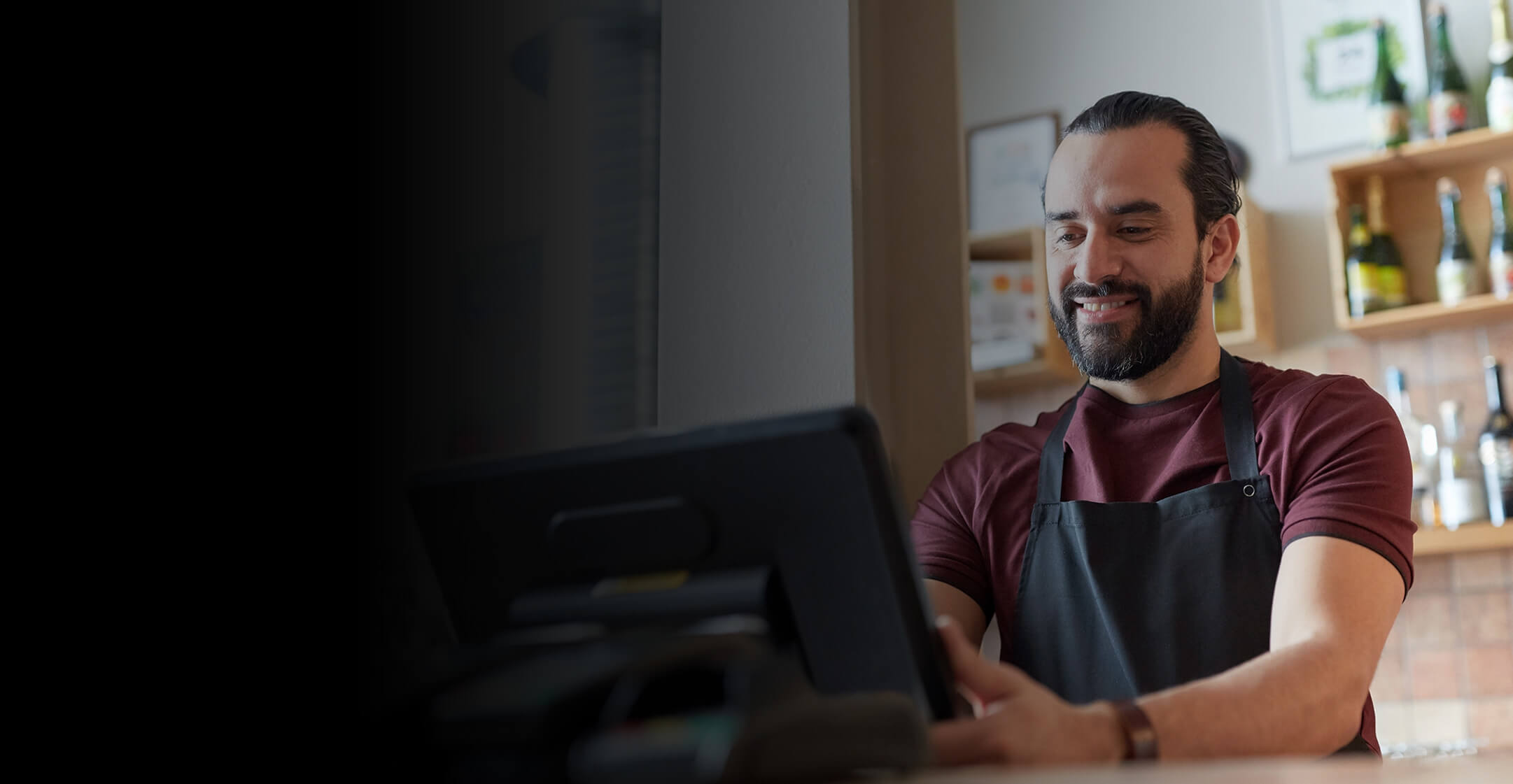 Retail staff member using a POS register