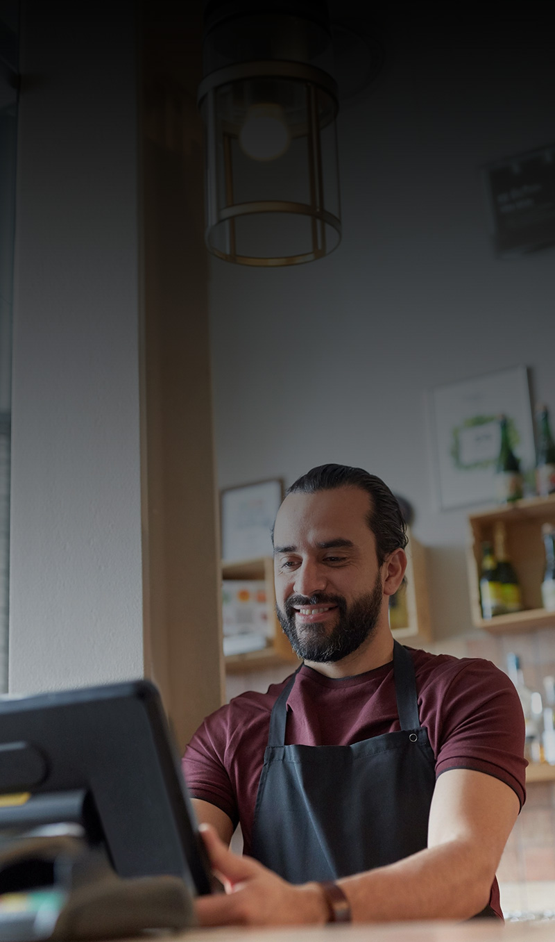 Retail staff member using a POS register