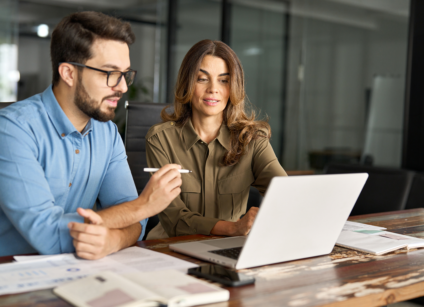 Two colleagues working at a laptop
