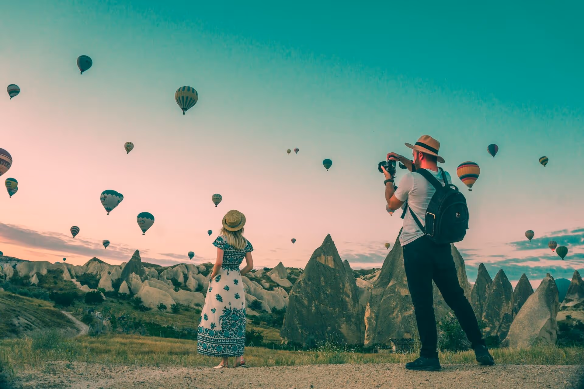 Photo being taken of women with a backdrop of balloons. 