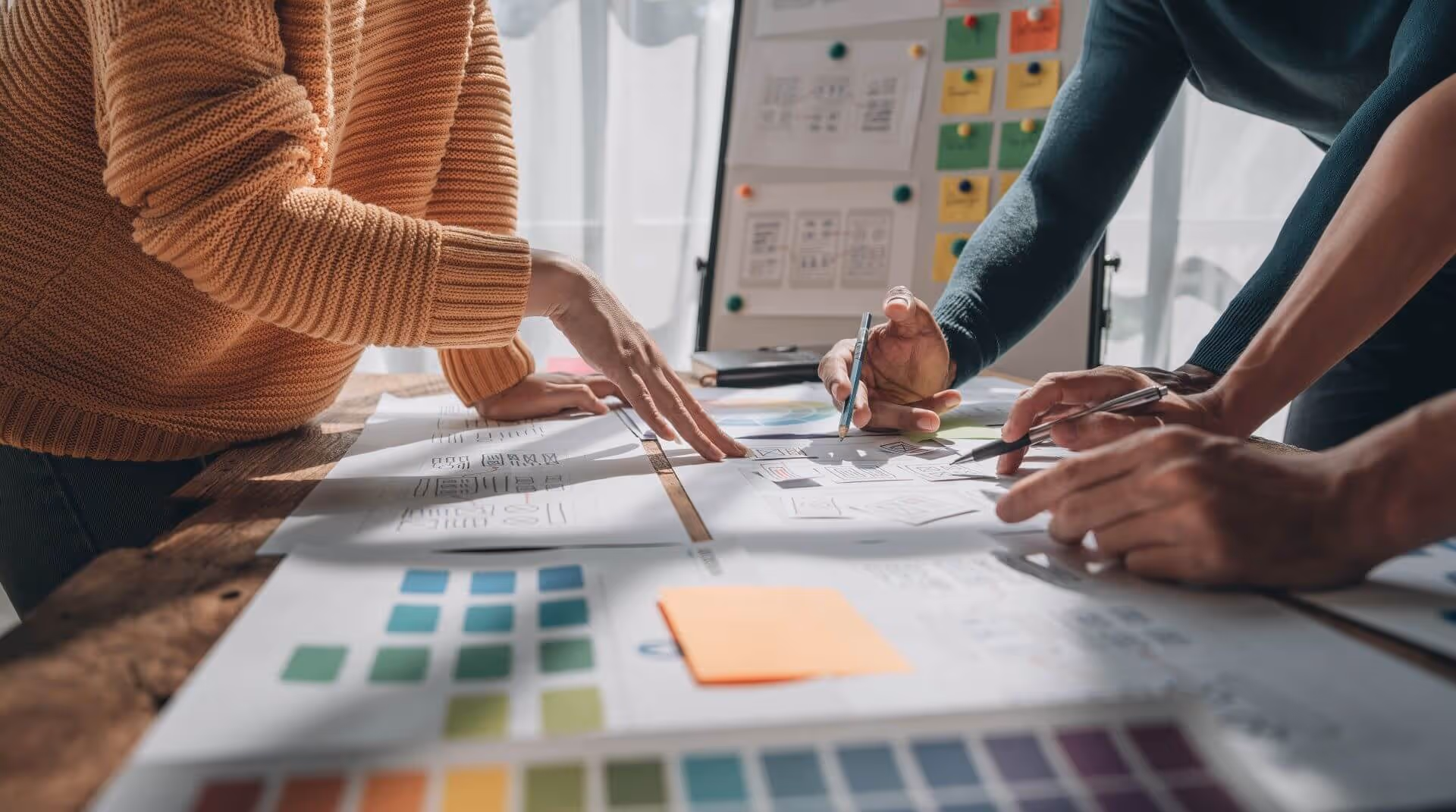 People discussing design plans on table