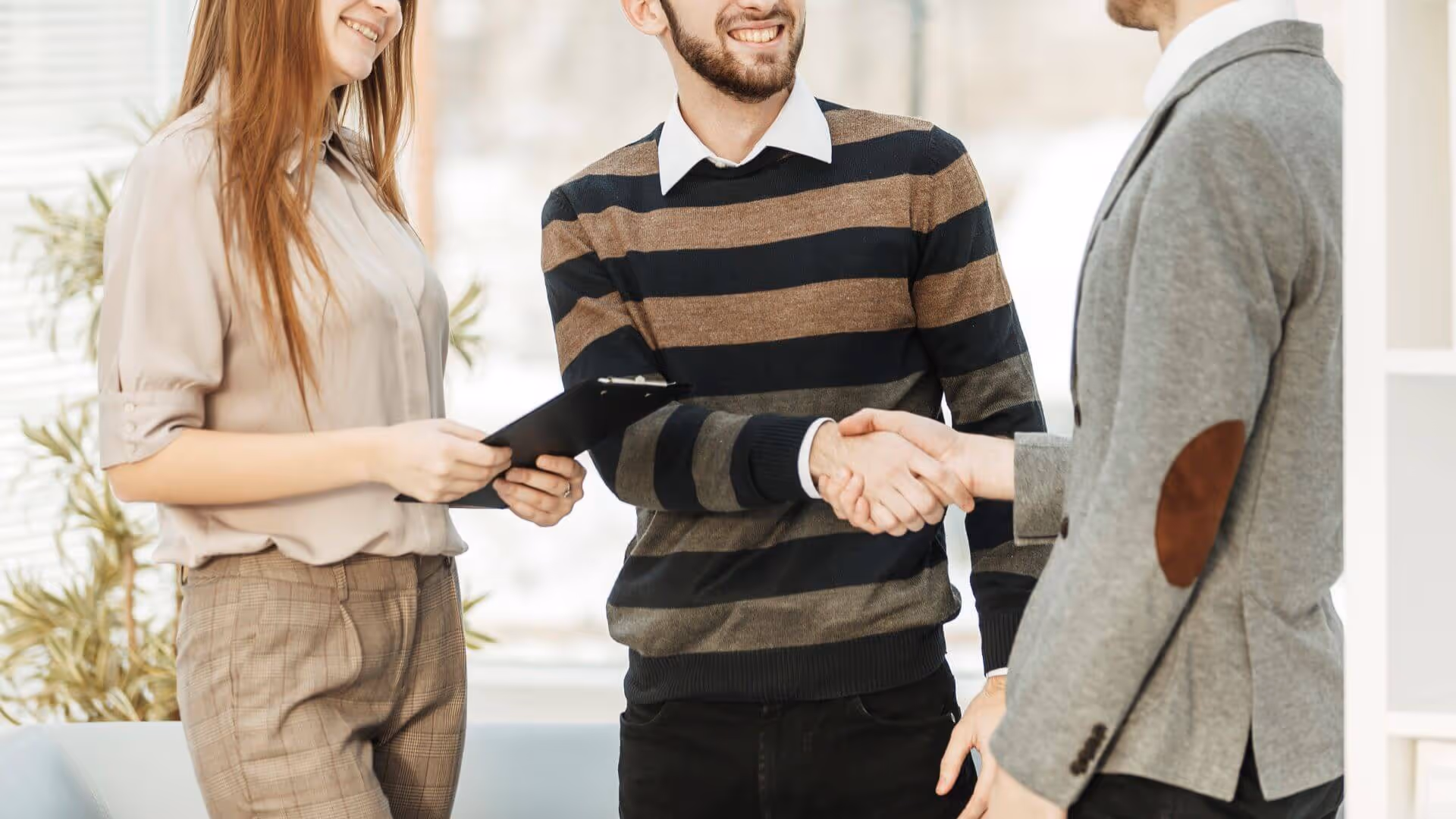 men shaking hands in modern office