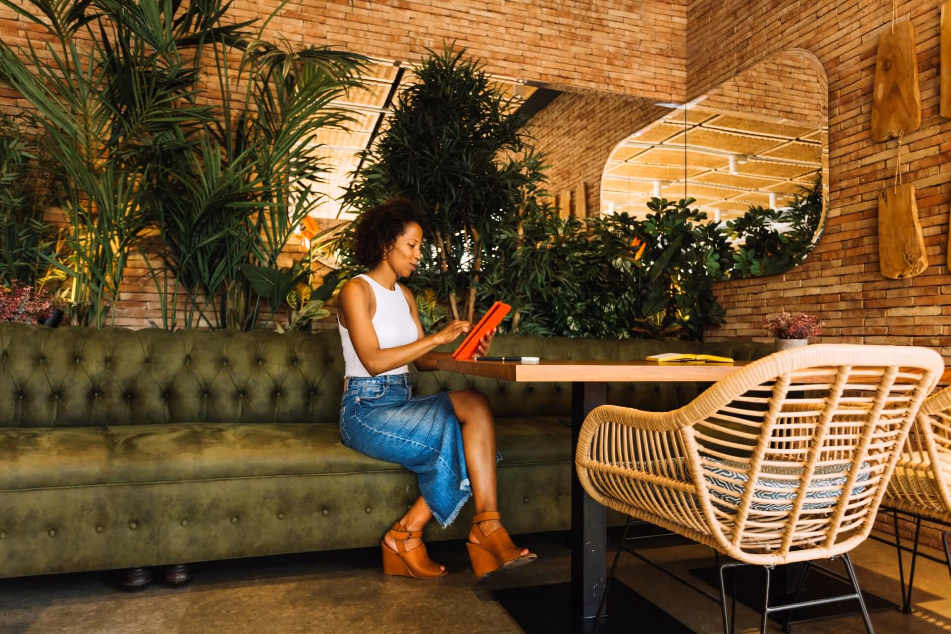 woman using tablet at restaurant table