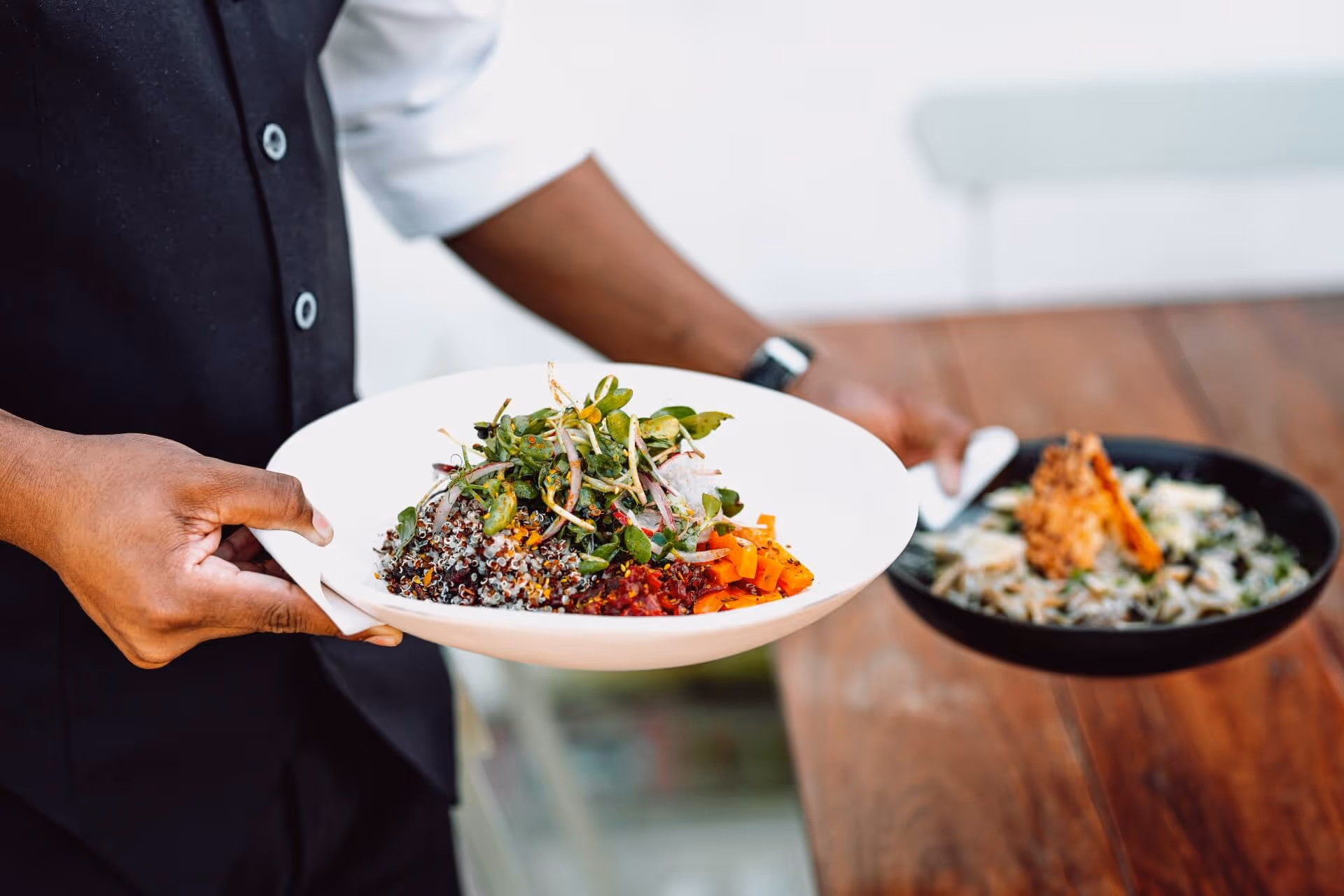 waiter serving two dishes