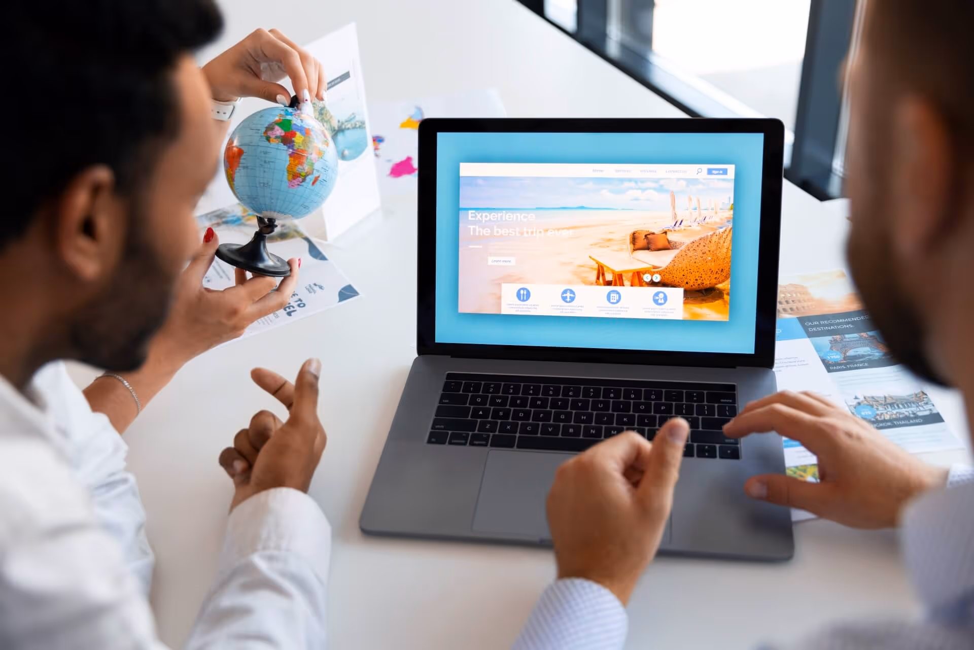 Friends planning a trip while looking at a laptop