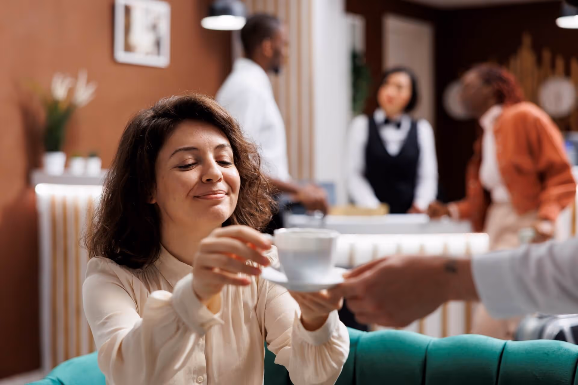 hotel porter serving woman with coffee