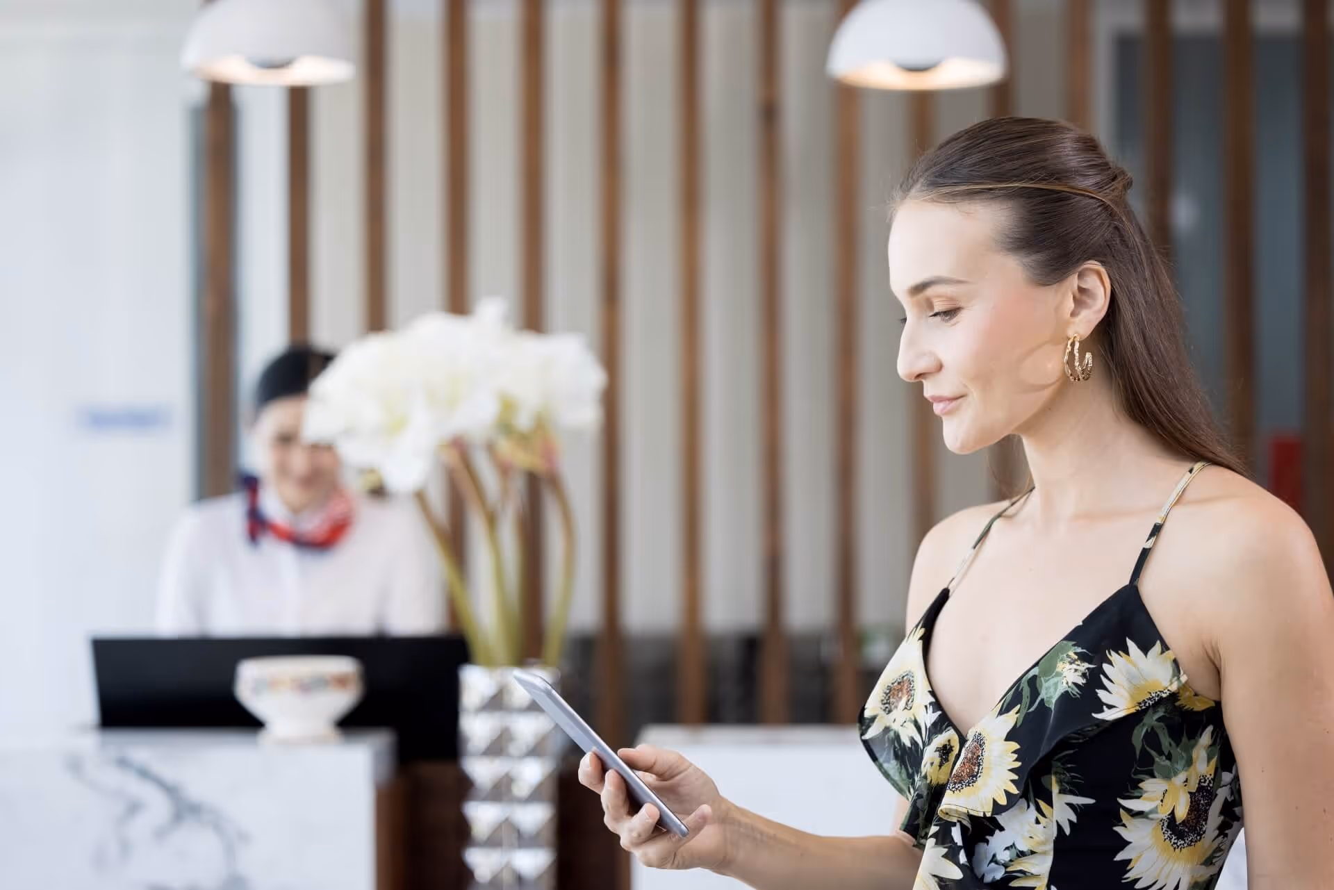 Women checking her smartphone at check-in desk 
