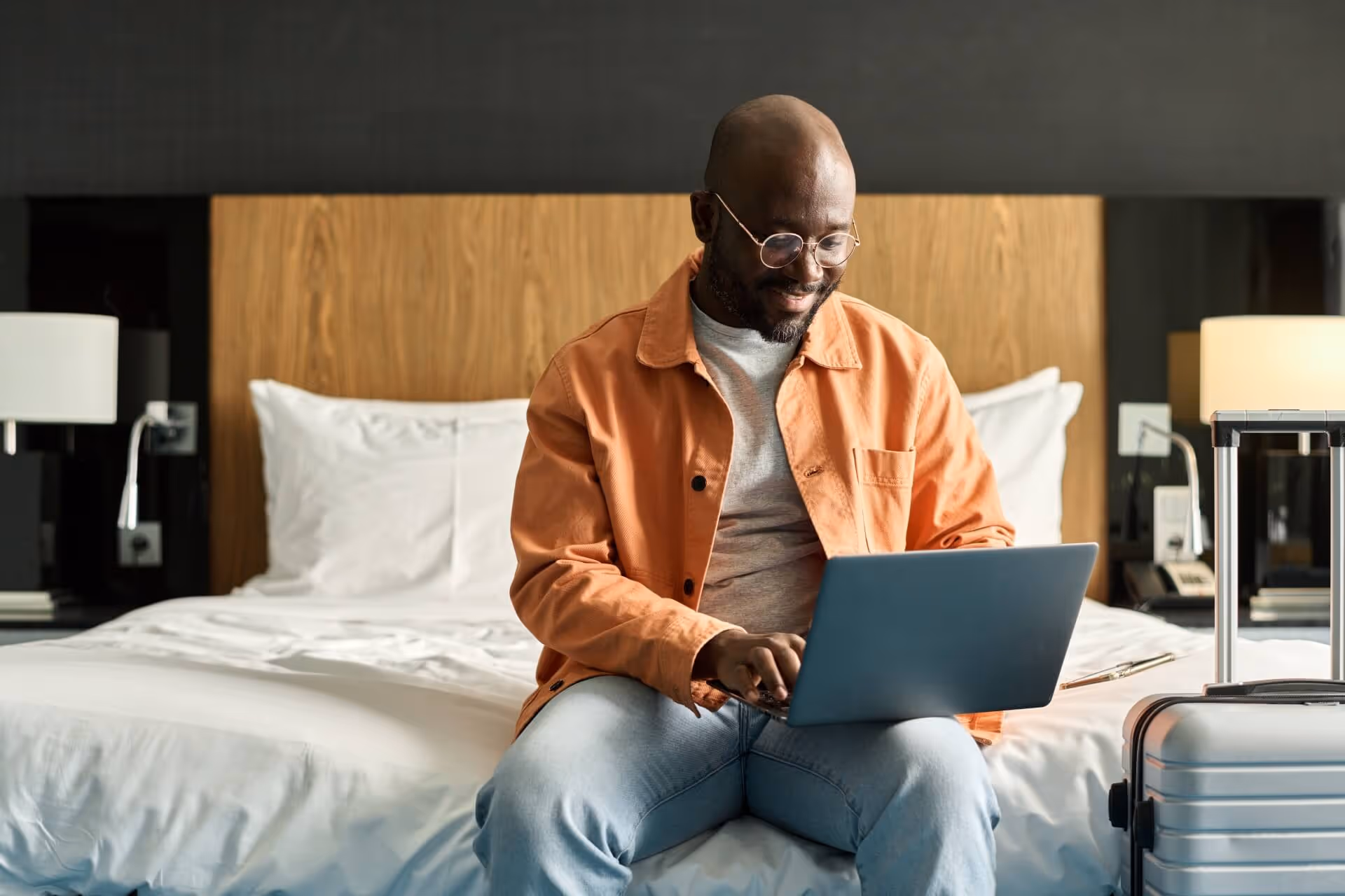Man using his laptop in hotel room