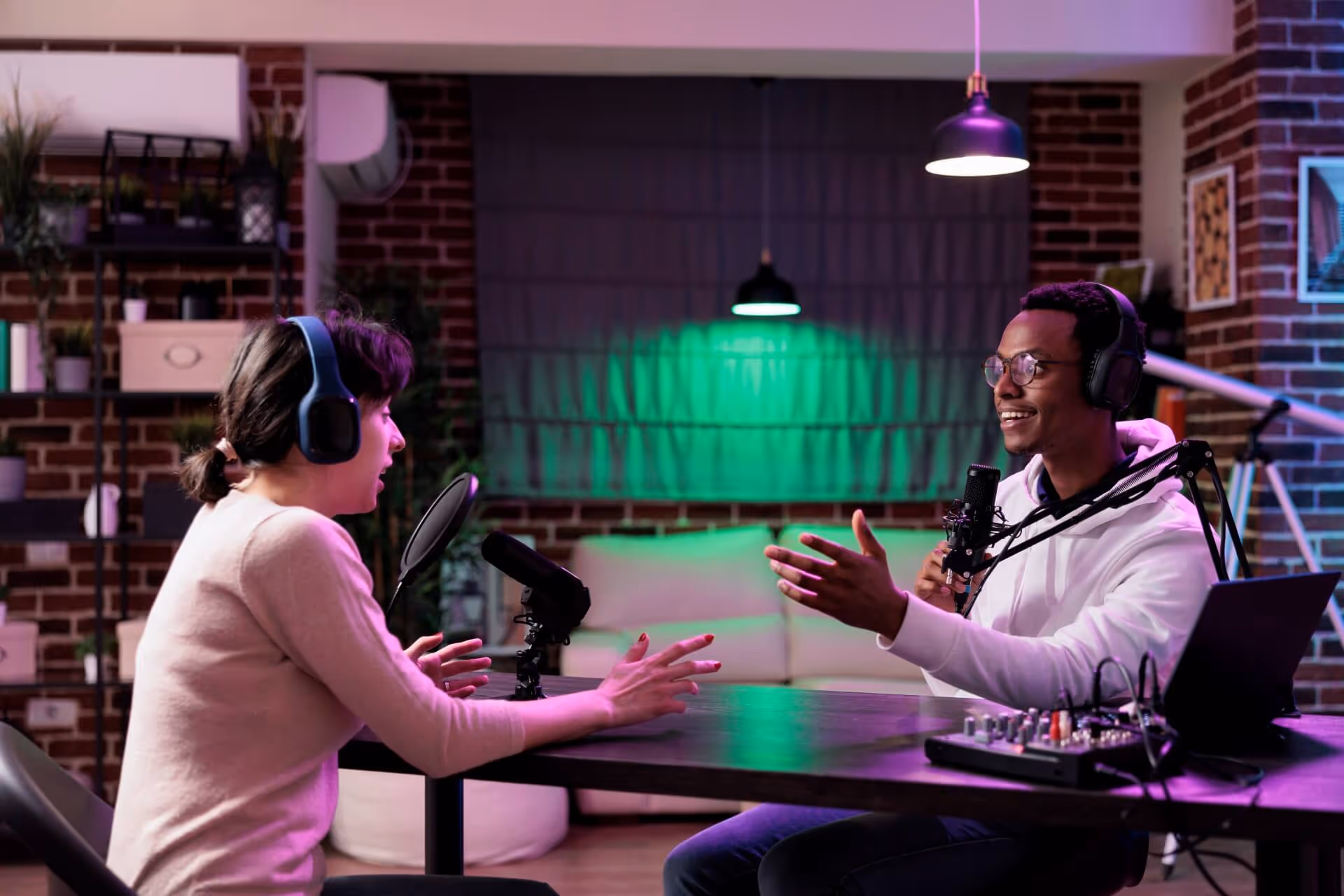 people in working studio and recording podcast