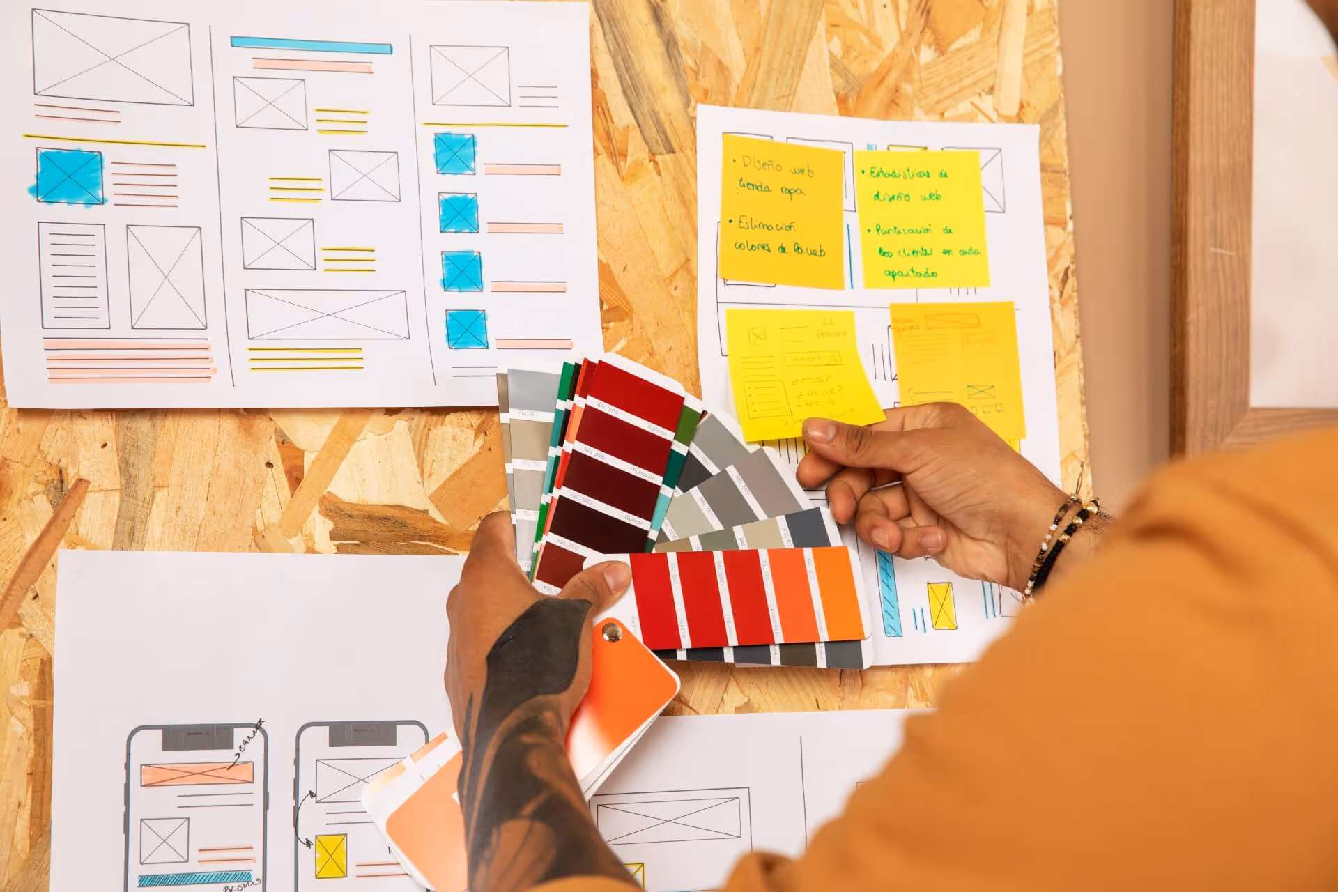 Person holding colour cards while viewing notes