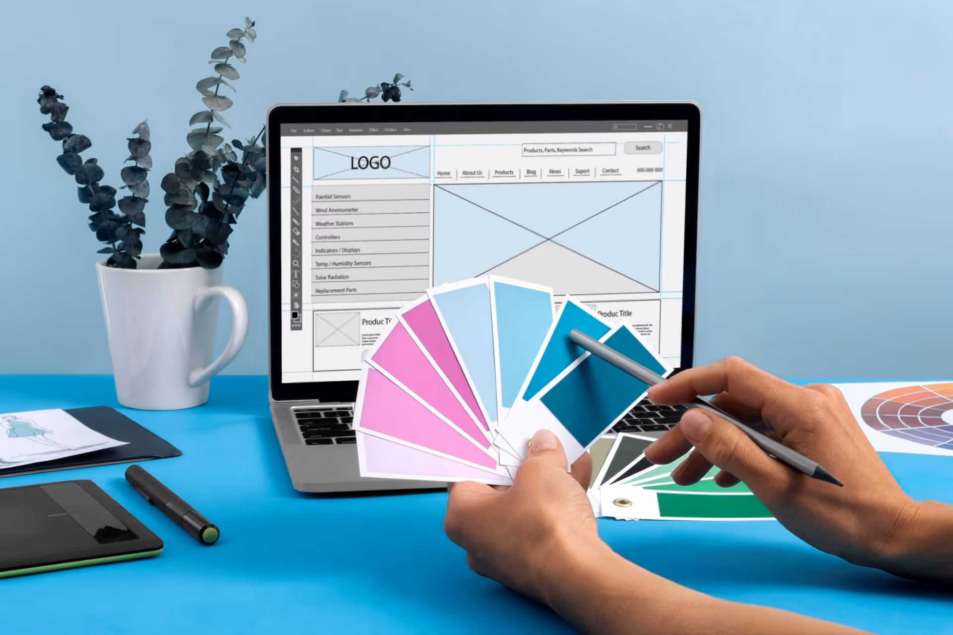 Person viewing colour templates in front of laptop