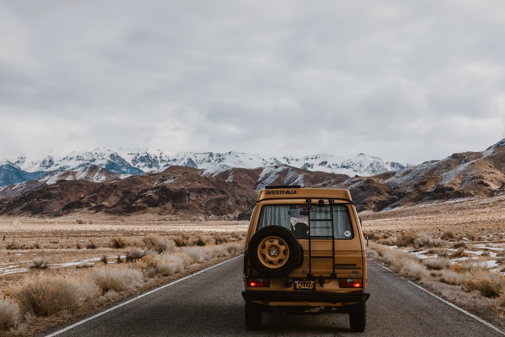 Vehicle on road under white sky